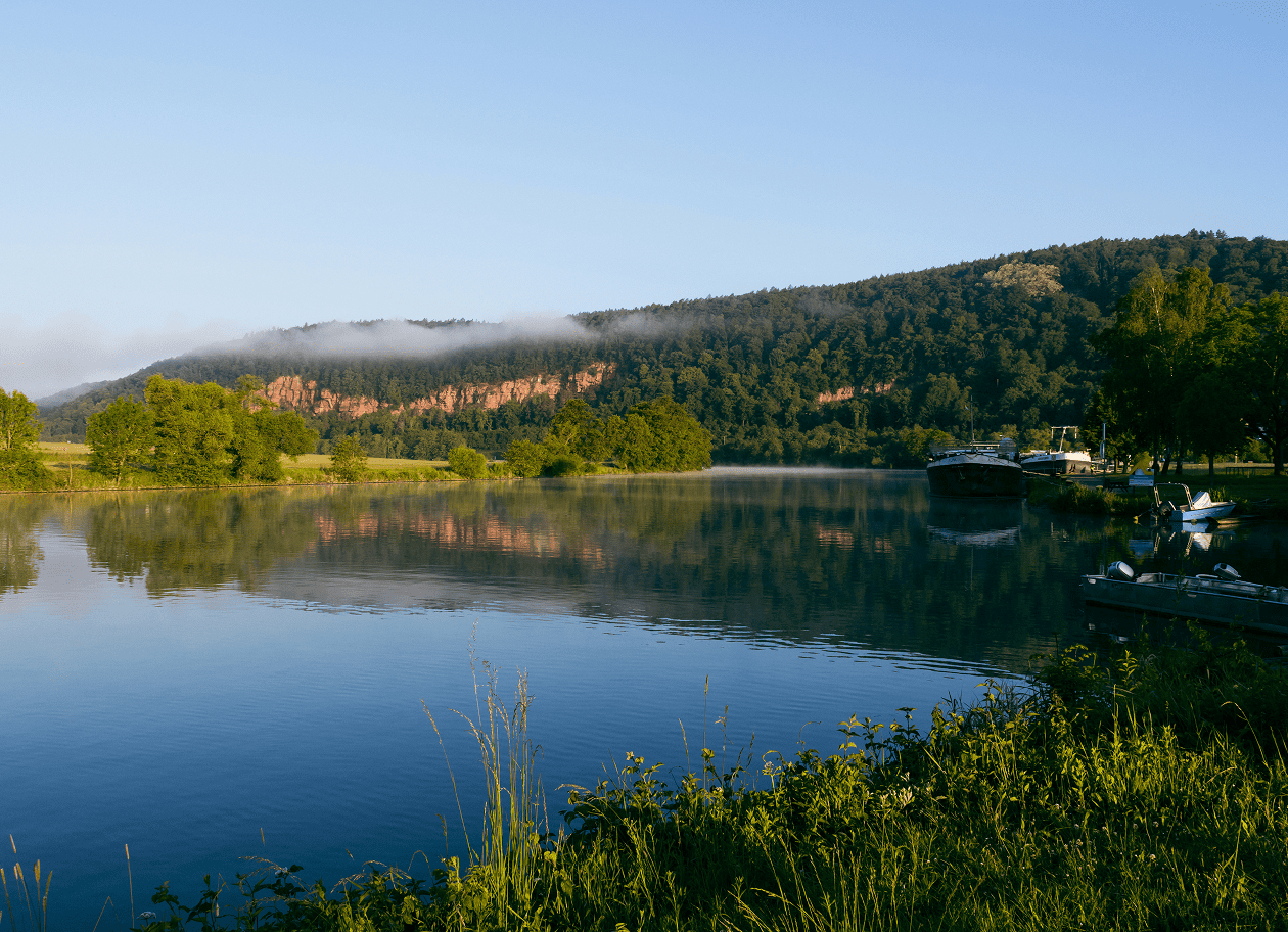 Ruhige Flusslandschaft bei Wertheim mit bewaldeten Hügeln